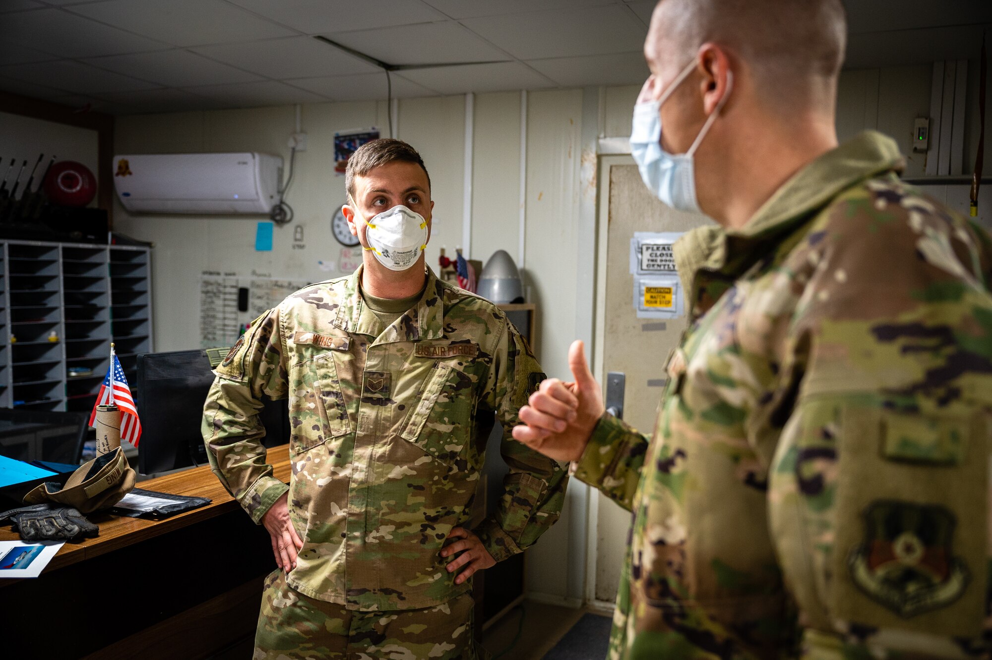 U.S. Air Force Chief Master Sgt. Sean M. Milligan, right, 332d Air Expeditionary Wing command chief, talks with Staff Sgt. Trenton Wing, 332d Expeditionary Logistics Readiness Squadron ground transportation support, about ground transportation during an immersion visit in Southwest Asia, Jan. 29, 2022. Chief Milligan's immersion visits give him a better understanding of the unique skillsets every Airman brings to the 332d AEW Red Tail team. (U.S. Air Force photo by Master Sgt. Christopher Parr)