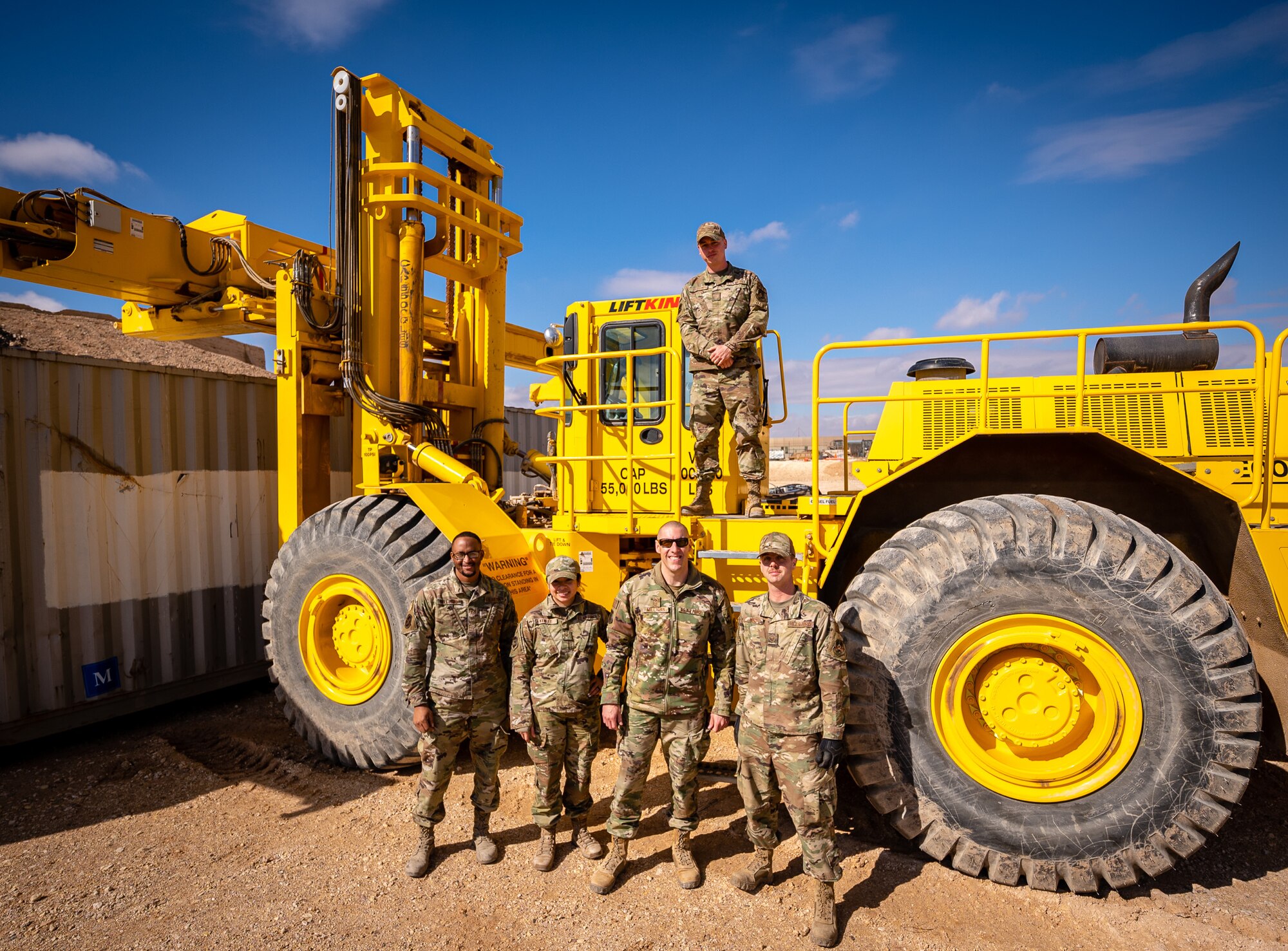 U.S. Air Force Chief Master Sgt. Sean M. Milligan, 332d Air Expeditionary Wing command chief, poses with 332d Expeditionary Logistics Readiness Squadron ground transportation support Airmen during the Command Chief’s immersion tour in Southwest Asia, Jan. 29, 2022. Chief Milligan's immersion visits give him a better understanding of the unique skillsets every Airman brings to the 332d AEW Red Tail team. (U.S. Air Force photo by Master Sgt. Christopher Parr)