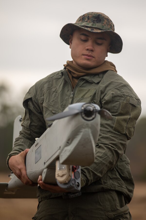 U.S. Marine Corps Cpl. Kirn Junsay, an assault amphibious vehicle crewman, and Thousand Oaks, California native with 2d Assault Amphibian Battalion (2d AABn), 2d Marine Division, holds a Puma Unmanned Aircraft System during a field exercise on Camp Lejeune, North Carolina, Jan. 25, 2022.