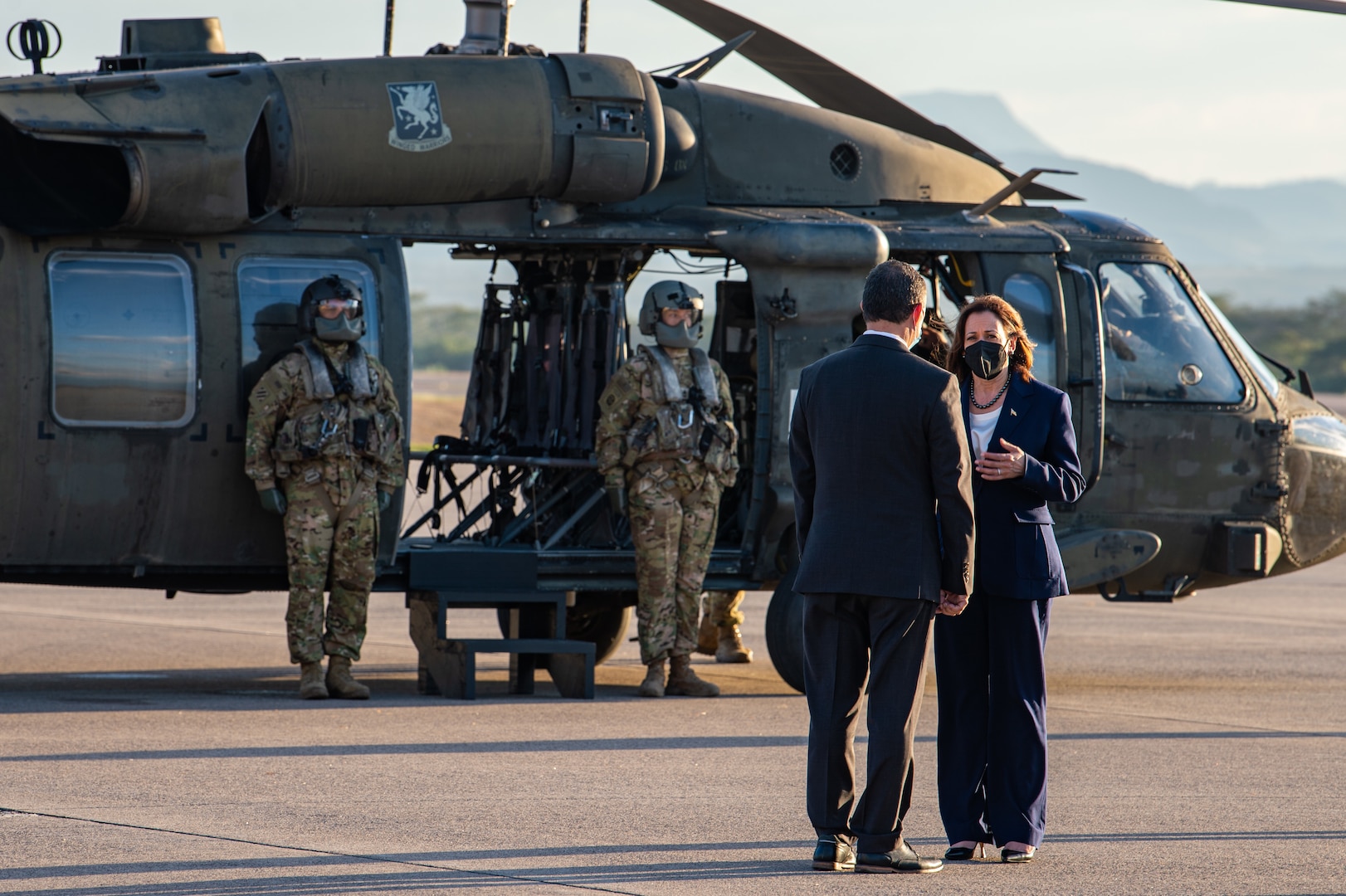 Vice President of the United States Kamala Harris speaks with a staff member after disembarking a UH-60 Blackhawk helicopter at Soto Cano Air Base, Honduras, Jan. 27, 2022.
