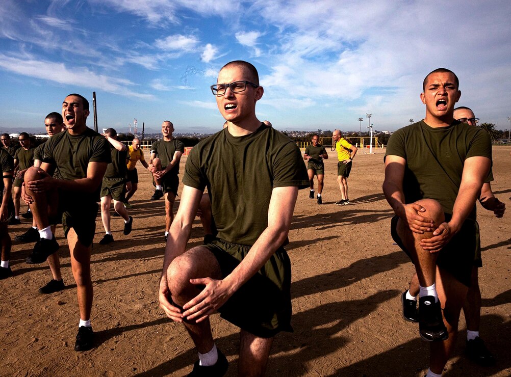 U.S. Marine Corps Recruits with Hotel Company, 2nd Recruit Training Battalion, conduct a warm up exercise during a physical training session at Marine Corps Recruit Depot, San Diego, Jan. 24, 2022.