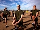 U.S. Marine Corps Recruits with Hotel Company, 2nd Recruit Training Battalion, conduct a warm up exercise during a physical training session at Marine Corps Recruit Depot, San Diego, Jan. 24, 2022.