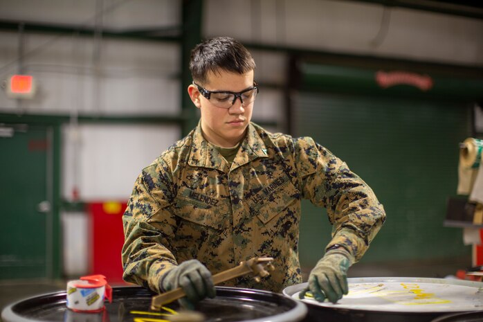 U.S. Marine Corps Lance Cpl. Angel Melendez, an airframes mechanic with Marine Medium Tiltrotor Squadron 162, Marine Corps Air Station New River, opens a barrel on MCAS New River in Jacksonville, North Carolina, Jan. 26, 2021. Melendez, the recipient of the January MCAS New River Go-Getter award, enlisted in the Marine Corps in January 2019 from Freehold, New Jersey.