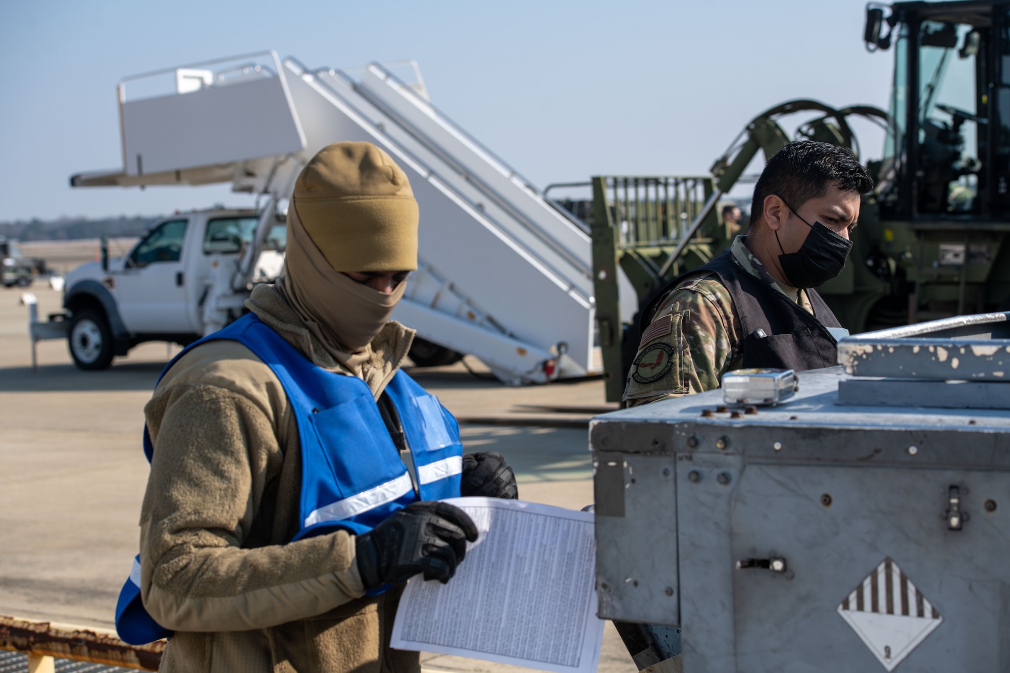 Photo of Airmen reading forms.