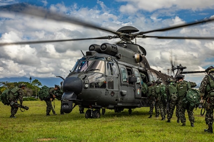 Brazilian army soldiers assigned to 5th Battalion, 12th Light Infantry (Air Assault), 2nd Division, enter a Eurocopter AS532 Cougar during Southern Vanguard 22 in Lorena, Brazil, Dec. 7, 2021. U.S. and Brazilian army soldiers took part in the air assault exercise, which was the largest deployment of a U.S Army unit to train with the Brazilian army forces in Brazil. (U.S Army photo by Pfc. Joshua Taeckens)