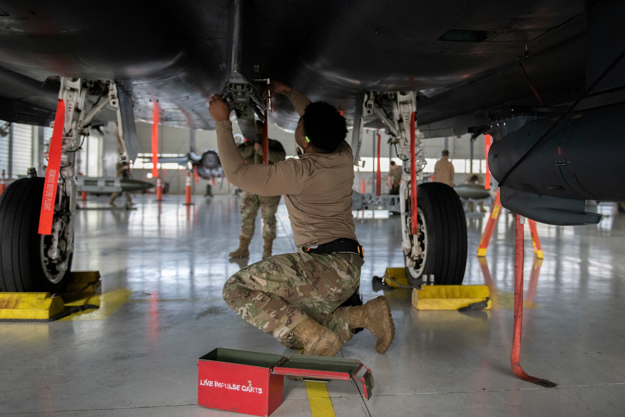 Airman prepares to load a GBU-10 E/B onto an F-15E Strike Eagle