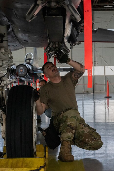 Airman inspects an F-15E Strike Eagle.