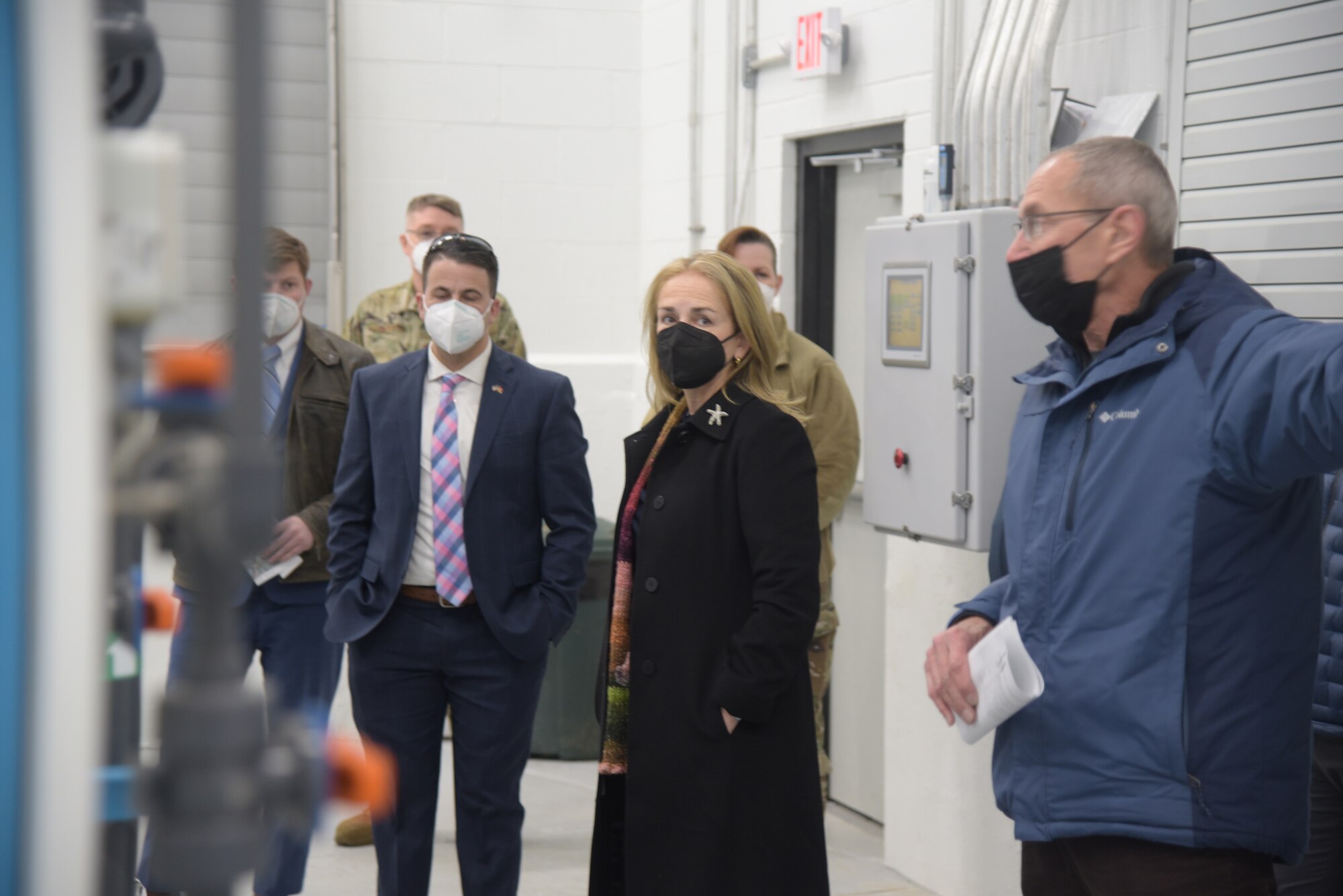 A man, a woman, and another man standing in a building.