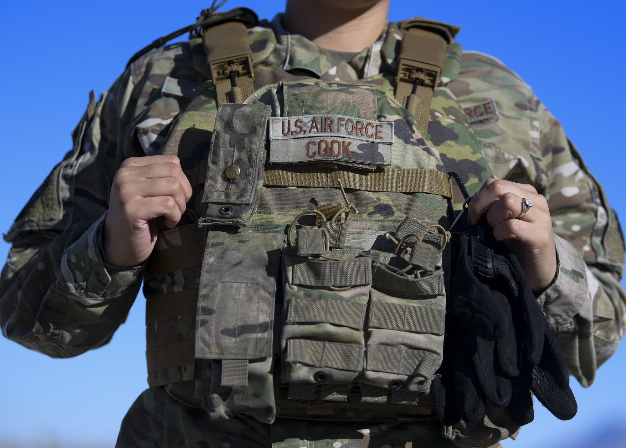 Senior Airman Kiah C. Cook, 377th Security Forces Group defender, donns her new body armor at Kirtland Air Force Base, N.M., Feb. 4, 2021. (U.S. Air Force photo by Airman 1st Class Ireland Summers)