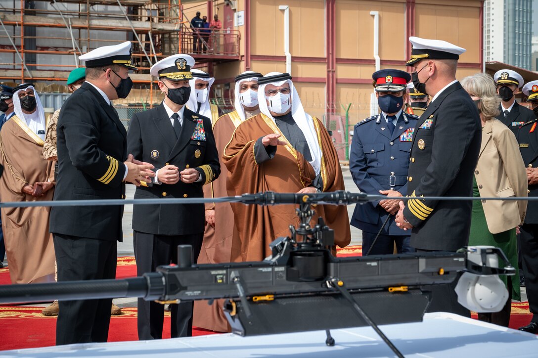 220131-N-OC333-1107 MANAMA, Bahrain (Jan. 31, 2022) His Royal Highness Prince Salman bin Hamad Al-Khalifa, Crown Prince, Deputy Supreme Commander and Prime Minister of Bahrain, center, receives a brief on the GHOST 4 unmanned aerial vehicle at Naval Support Activity Bahrain, Jan. 31.