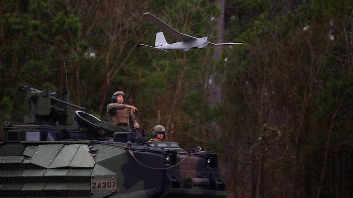 U.S. Marine Corps Sgt. Wilfredo Hernandez, an assault amphibious vehicle crewman, and Voorhees, New Jersey native, with 2d Assault Amphibian Battalion (2d AABn), 2d Marine Division, launches a Puma Unmanned Aircraft System during a field exercise on Camp Lejeune, North Carolina, Jan. 25, 2022. 2d AABn tested the capability of an assault amphibious vehicle and a light armored vehicle with Remote Weapon Systems as a suitable land-based platform for mobile reconnaissance and scouting. (U.S. Marine Corps photo by Lance Cpl. Ryan Ramsammy)