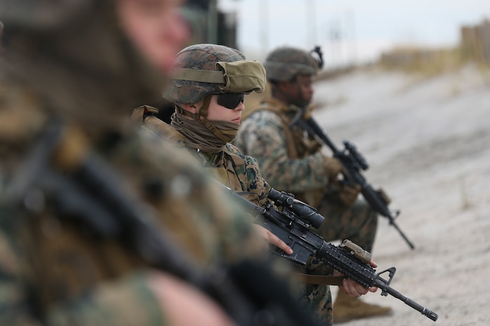 U.S. Marines with 2d Marine Logistics Group and 2d Marine Division provide security while transporting vehicles onto a Landing Craft Air Cushion during a Type Commander’s Amphibious Training (TCAT) on Camp Lejeune, North Carolina, Jan. 20, 2022. TCAT is a mobility exercise ashore that allows Marines to gain the requisite skills and experience to integrate with the U.S. Navy in follow-on exercises and real-world operations. (U.S. Marine Corps photo by Lance Cpl. Megan Ozaki)