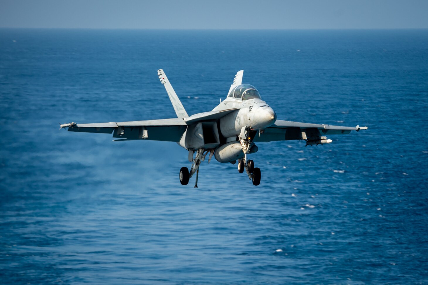 An F/A-18E Super Hornet, assigned to the "Bounty Hunters" of Strike Fighter Squadron (VFA) 2, prepares to recover on the flight deck of Nimitz-class aircraft carrier USS Carl Vinson (CVN 70).