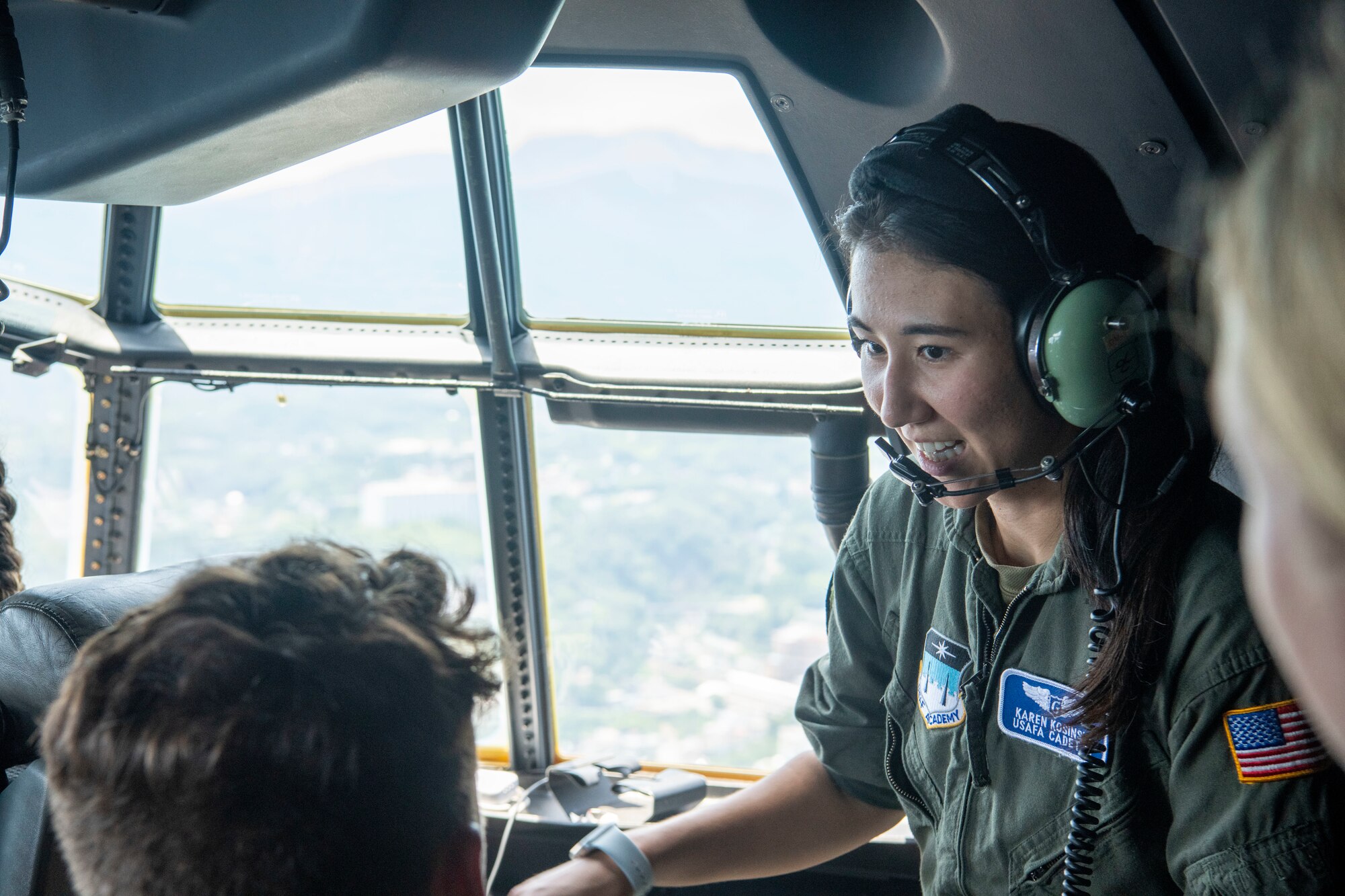 a female cadet talks to aircrew mid-flight