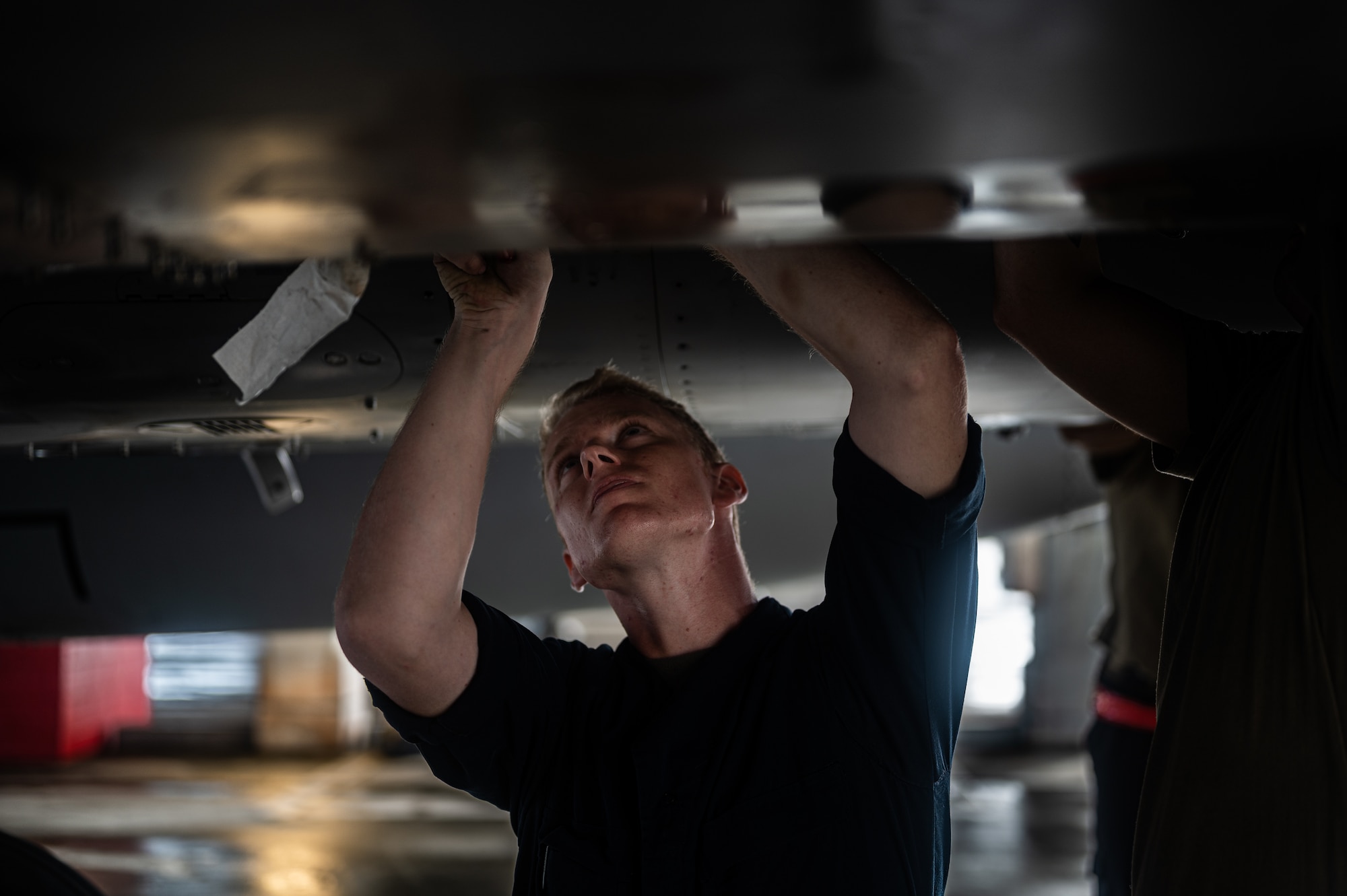 Airman works on aircraft.