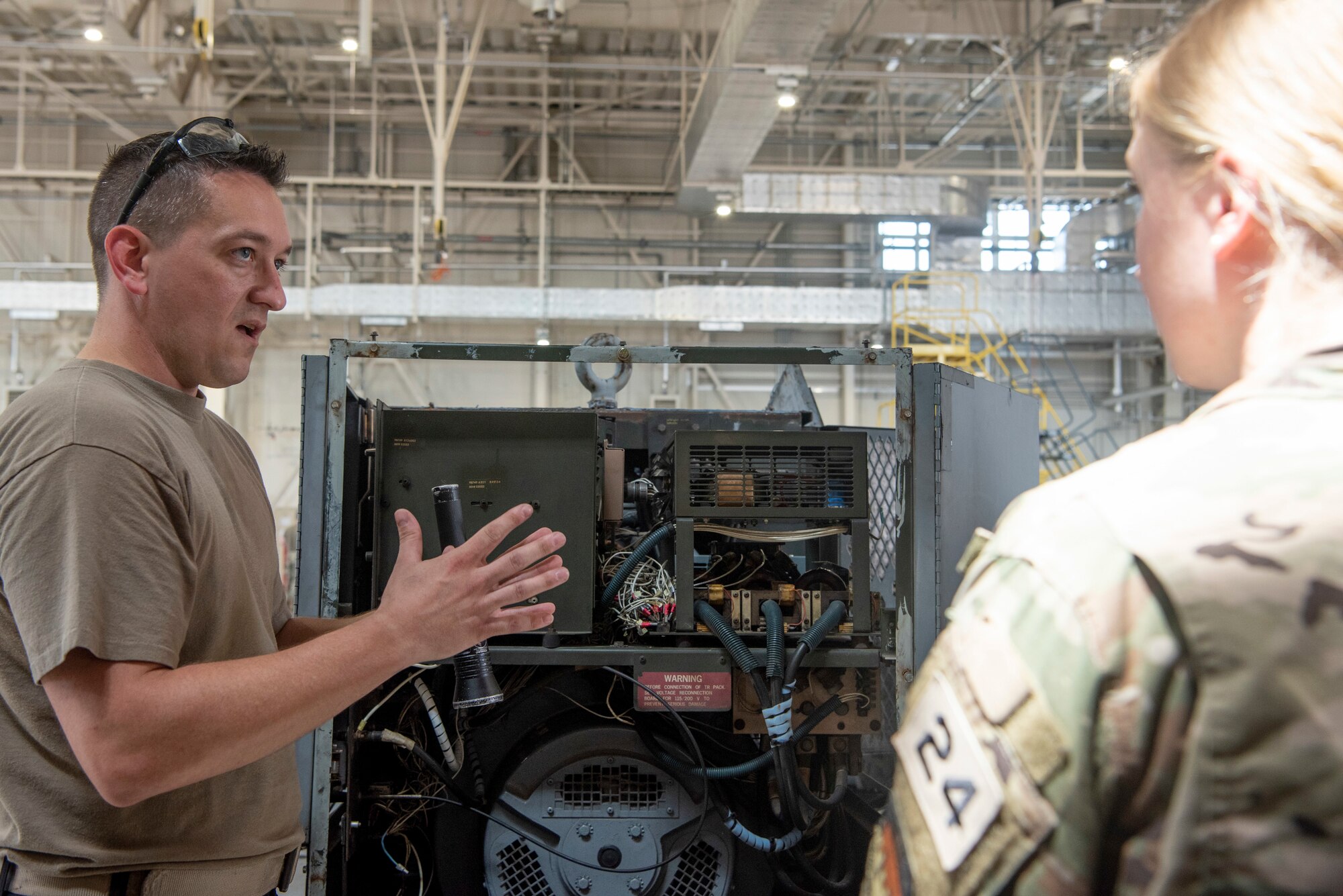 Tech. Sgt. Robert Warner, 374th Maintenance Squadron Maintenance NCO in charge, explains how a generator used on the flightline to a United States Air Force Academy cadets at Yokota Air Base, Japan, June 29, 2022.