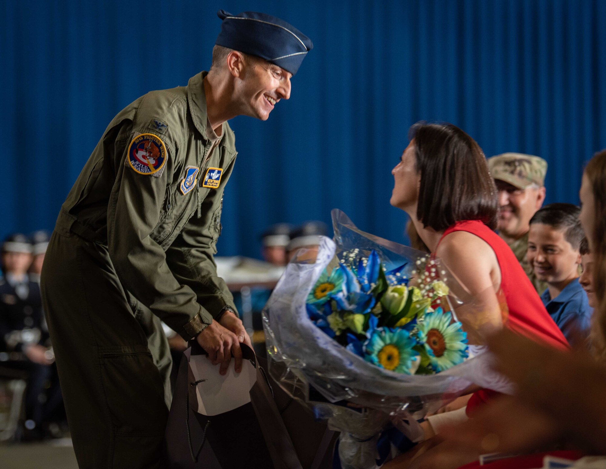 United States Air Force Col. Michael P. Richard, 35th Fighter Wing (FW) incoming commander, gives his wife, Jessica, flowers during the 35th FW change of command ceremony at Misawa Air Base, Japan, June 30, 2022.