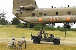 National Guard Soldiers from the Pacific Northwest trained in sling-load maneuvers in June at Camp Rilea in Oregon. The helicopter is from Detachment 1, Company B, 1st Battalion, 168th Aviation, Oregon Army National Guard.