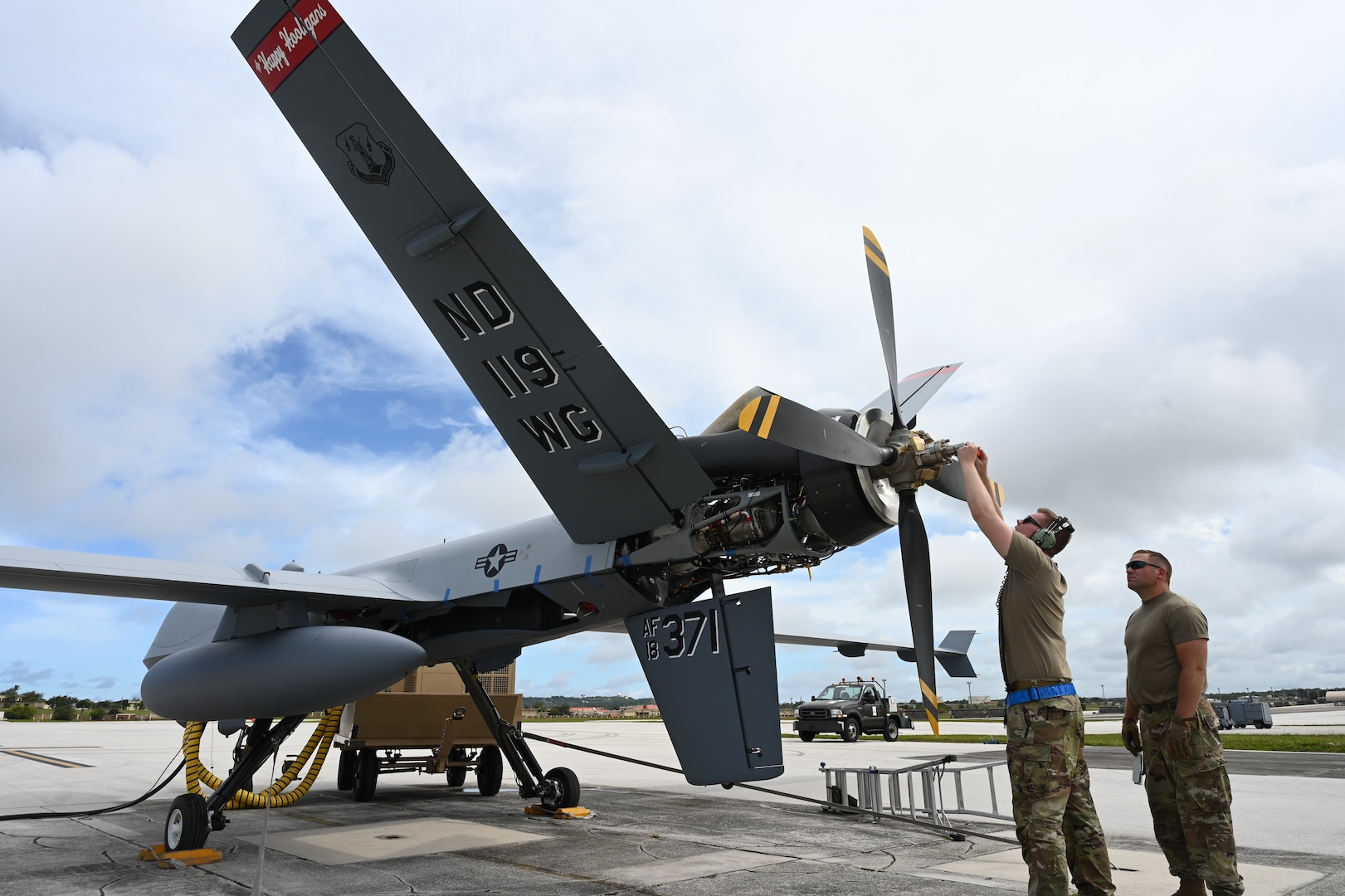 U.S. Air Force members of the 119th Wing adjust propeller weight during MQ-9 preflight checks at Andersen Air Force Base, Guam, during Exercise Valiant Shield May 27, 2022. The 12-day joint field training exercise enhanced integration between U.S. forces during joint operations at sea, on land, in air, and in cyberspace.