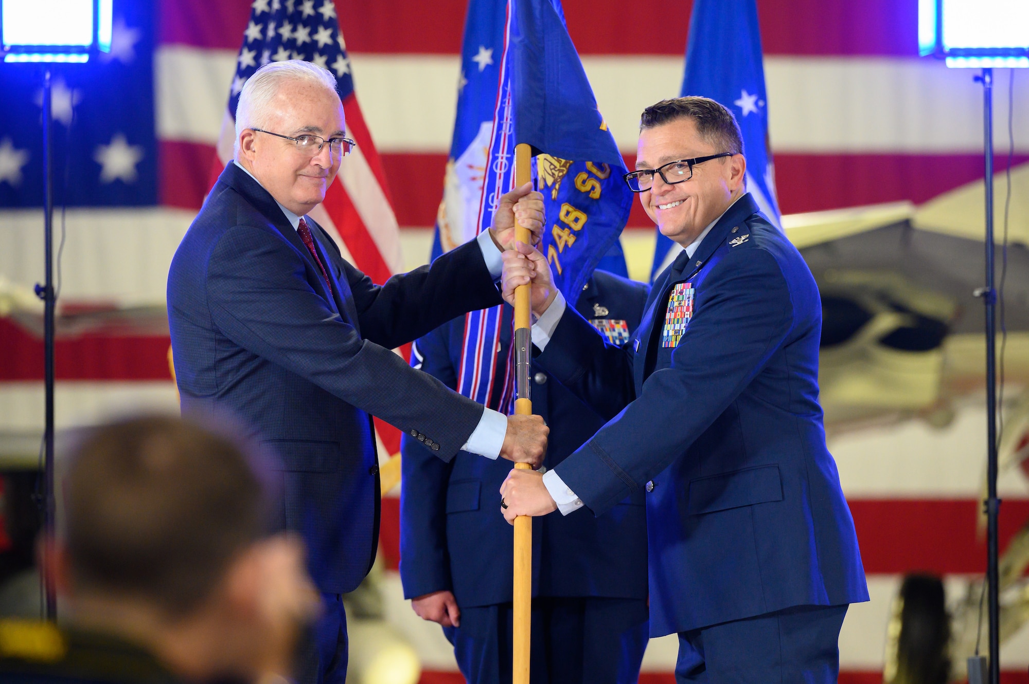 Right, Col. Christopher Carmichael, incoming 748th Supply Chain Management Group commander, receives the guidon from Stephen Gray, 448th Supply Chain Management Wing director, during a change of command ceremony at Hill Air Force Base, Utah, June 30, 2022. The 748th SCMG sustains weapon systems worldwide by providing supply chain management life cycle support to include developing enterprise demand and supply plans, developing and implementing sourcing strategies, executing the supply plan, and executing cognizant engineering authority to meet customer requirements for aircraft structural and avionics systems, landing gear, secondary power systems, and space & command, control, communications and intelligence commodities. (U.S. Air Force photo by R. Nial Bradshaw)