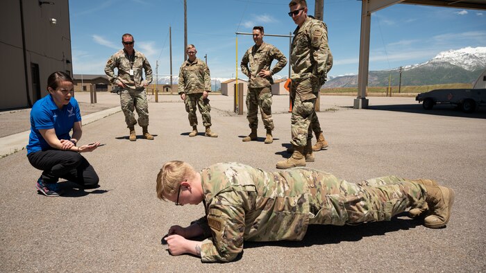Lt. Col. Ember Ryals, 75th Medical Group Operation Support Team flight commander, administers a time core strength assessment at Hill Air Force Base, Utah,