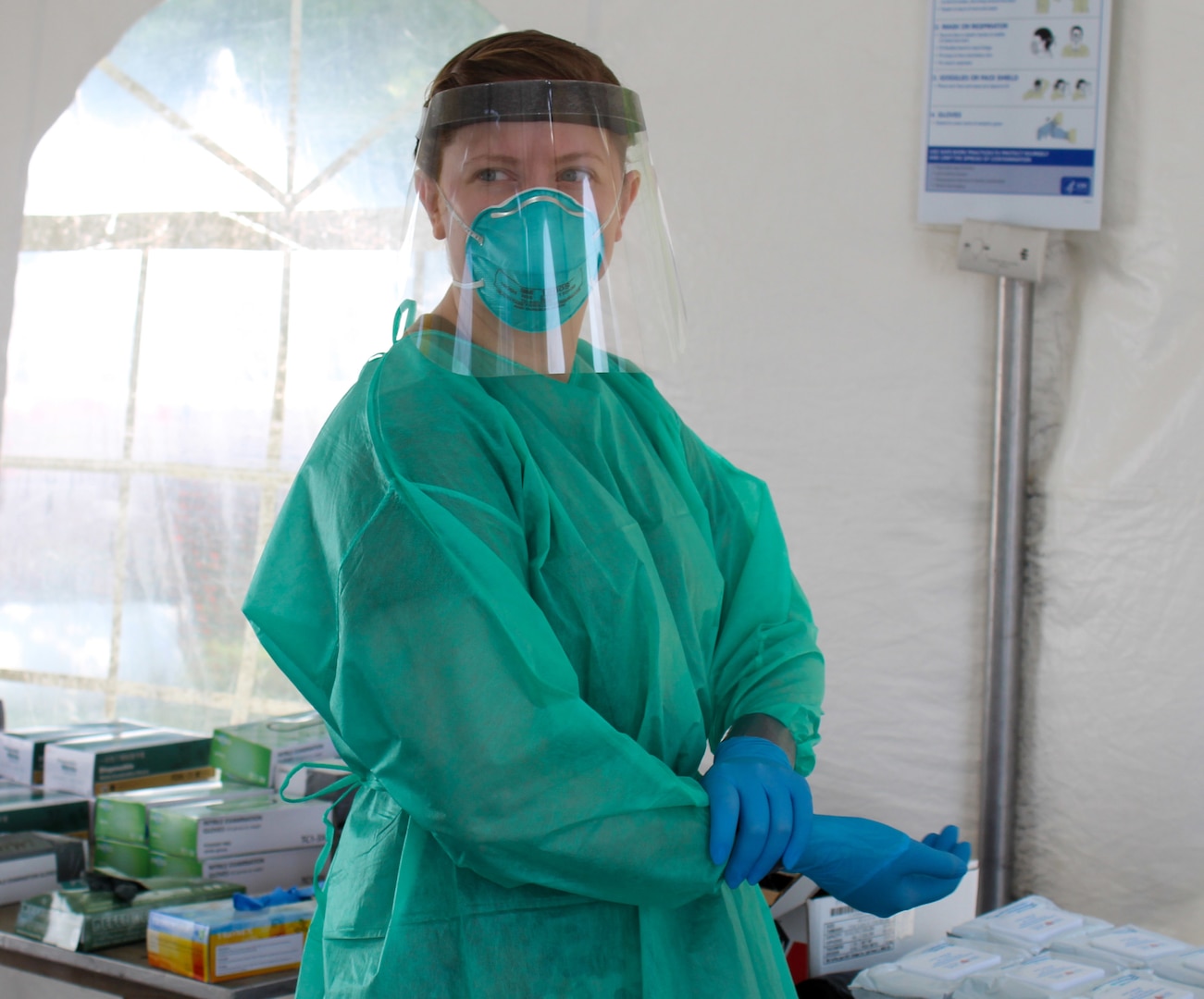 Senior Airman Alyssa Volkner, assigned to the 139th Air Medical Evacuation Squadron, prepares to administer COVID-19 tests at a drive-thru site at The State University of New York, Albany, July 9, 2020.