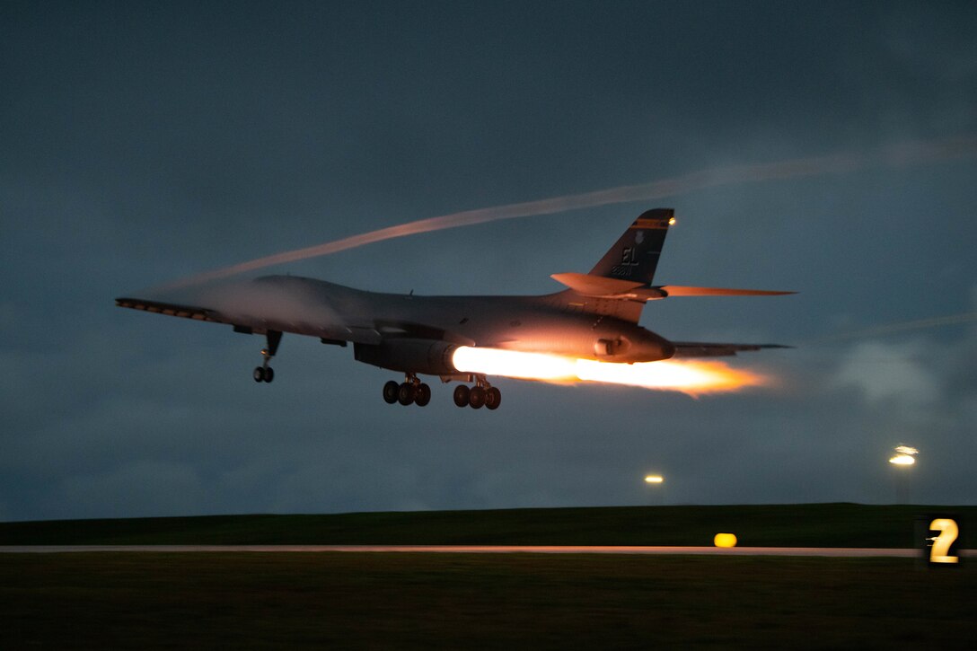 A large bomber aircraft takes off at night.