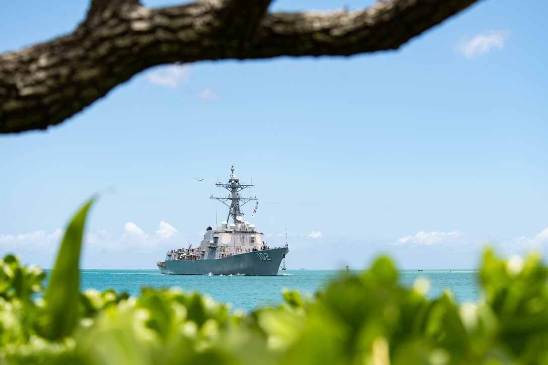 A military ship is seen from land.
