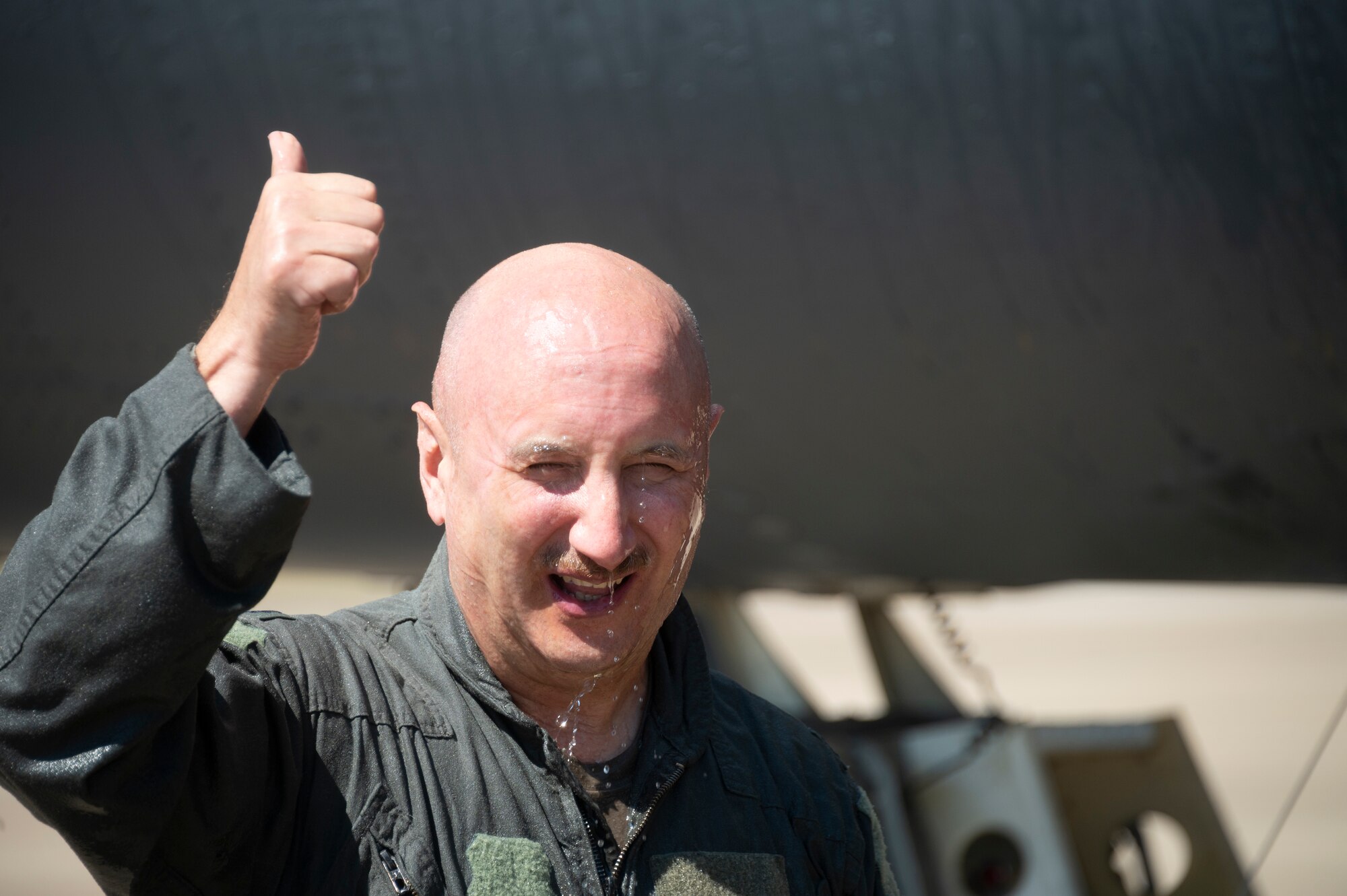 An airman gives the thumbs up sign