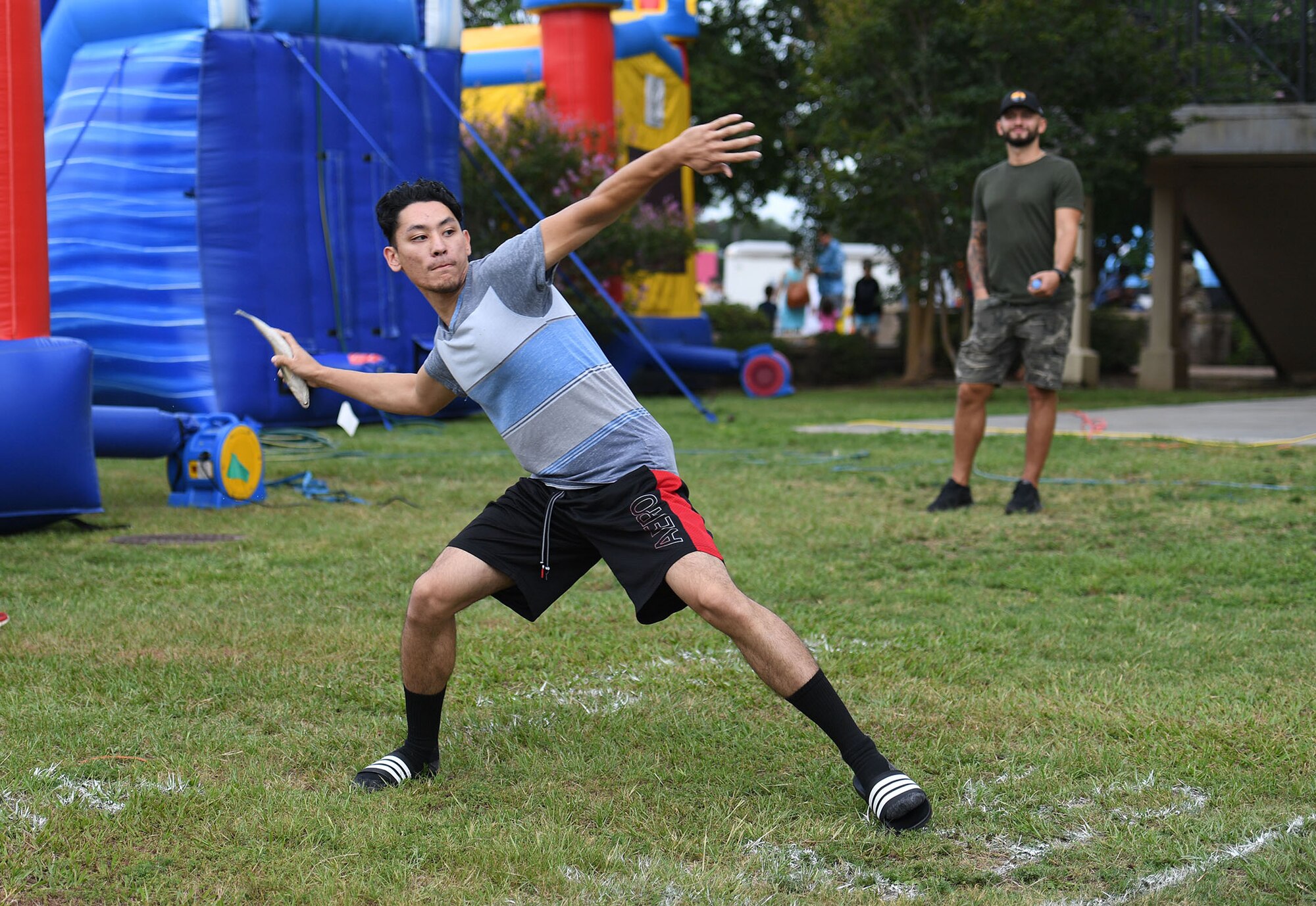 U.S. Air Force Airman 1st Class Jacob Jozefick, 81st Operations Support Flight radar airfield and weather systems technician, participates in a frozen mullet toss competition during Freedom Fest at the Bay Breeze Event Center on Keesler Air Force Base, Mississippi, June 30, 2022. The event also included hot wings and watermelon eating contests and fireworks. (U.S. Air Force photo by Kemberly Groue)