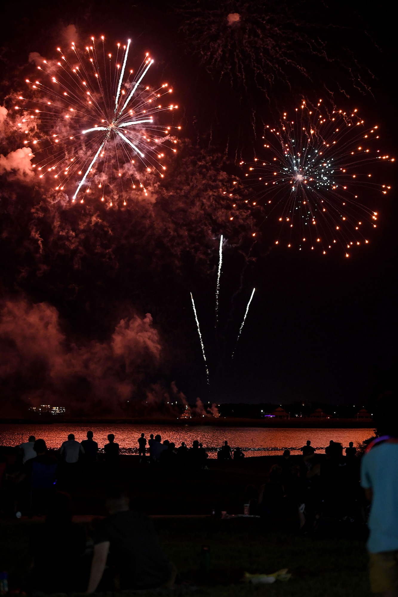 Keesler personnel and families watch a fireworks display during Freedom Fest at the Bay Breeze Event Center on Keesler Air Force Base, Mississippi, June 30, 2022. The event also included a wing eating contest and a frozen mullet toss competition. (U.S. Air Force photo by Kemberly Groue)
