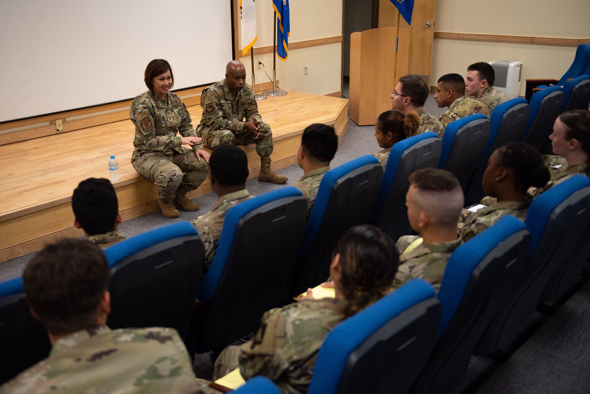 Chief Master Sgt. of the Air Force JoAnne S. Bass, left, and Chief Master Sgt. Nathaniel M. Perry, Air Force first sergeant special duty manager, speak with Airmen attending the First Term Airmen brief at Osan Air Base, June 28, 2022.