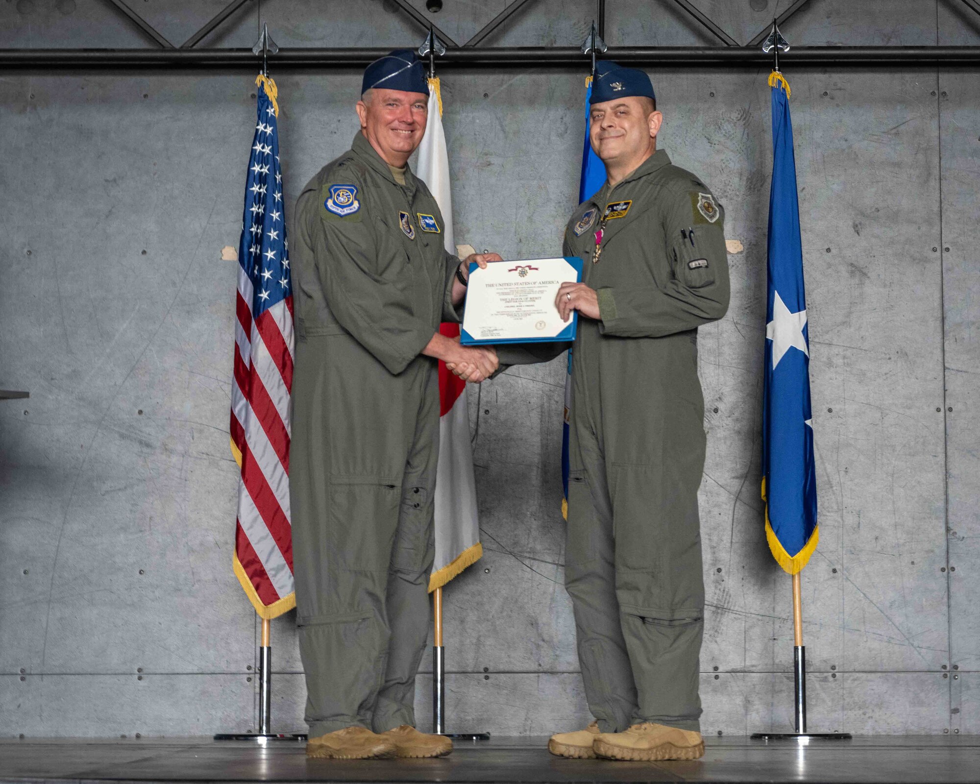 United States Air Force Lt. Gen. Ricky N. Rupp, U.S. Forces Japan and 5th Air Force commander, left, presents the Legion of Merit to Col. Jesse J. Friedel, 35th Fighter Wing (FW) outgoing commander, during the 35th FW change of command ceremony at Misawa Air Base, Japan, June 30, 2022.