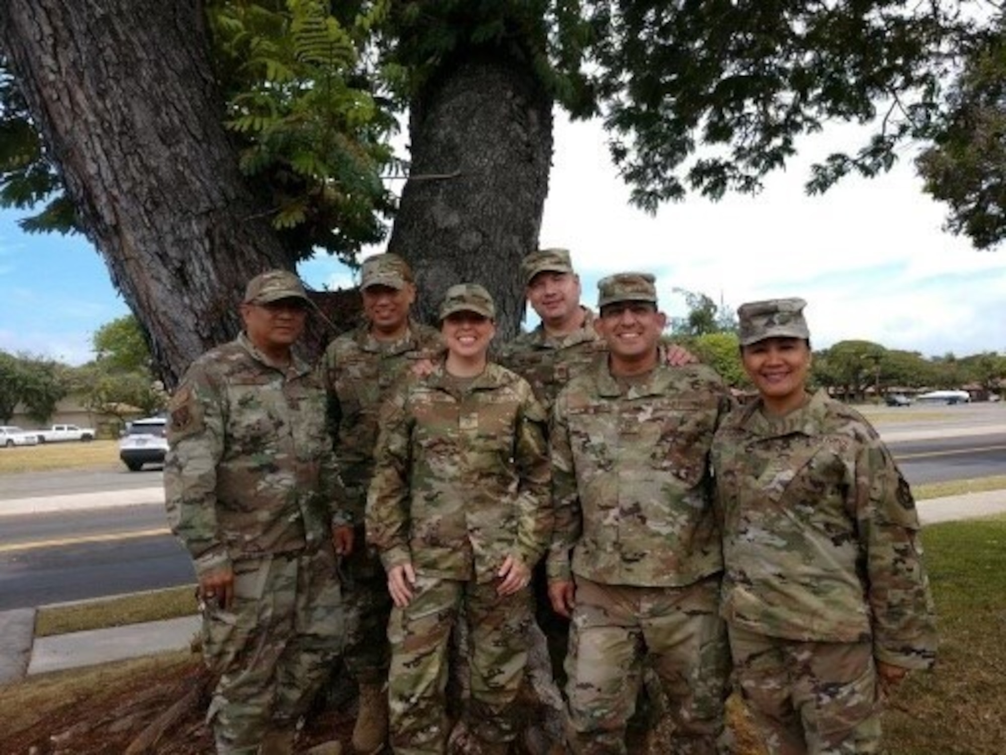 Senior AGRs and ARTs pose in front of a tree during a break from their three-day working retreat.