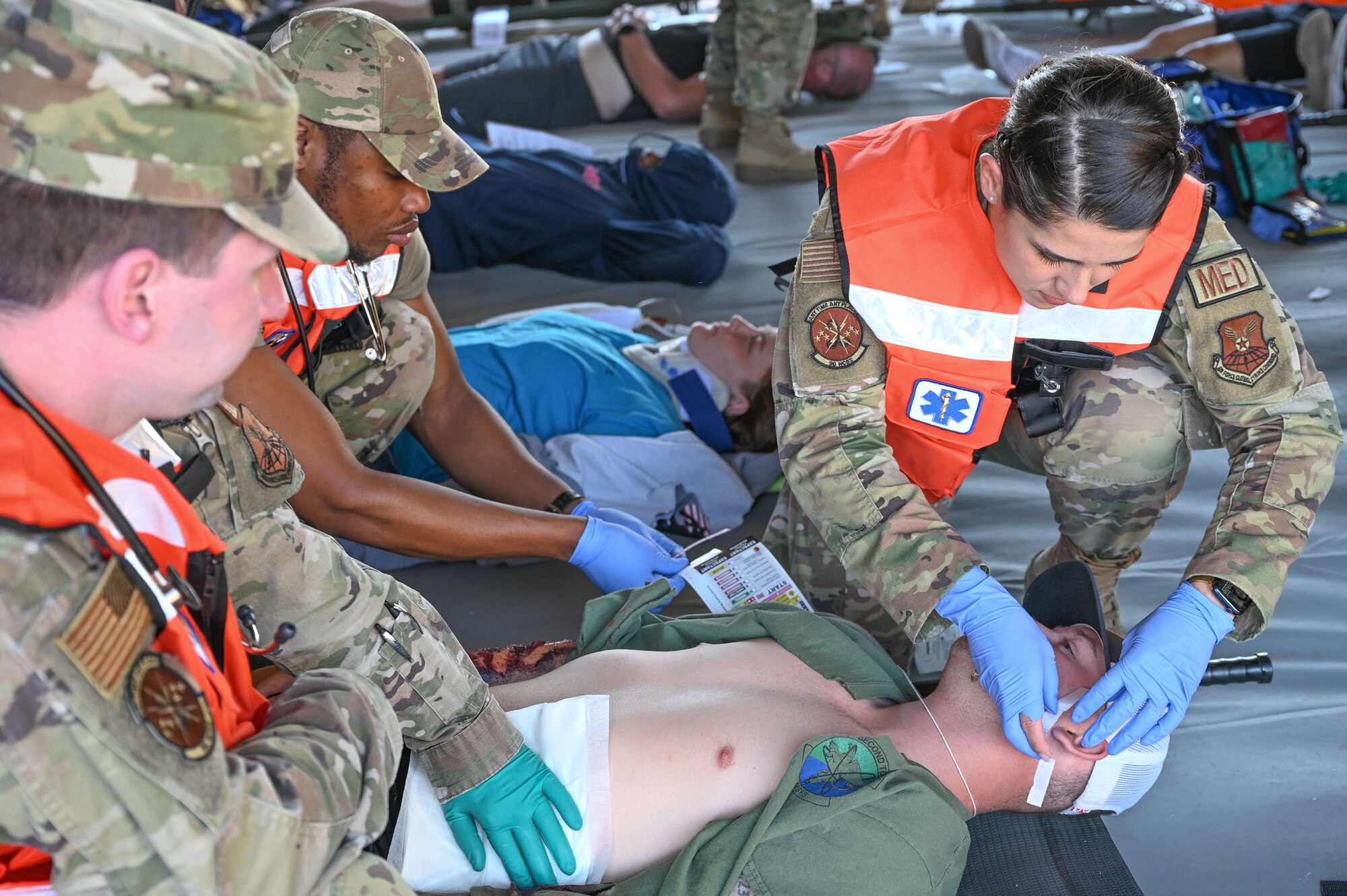 Senior Airman Brody Swab, 790th Missile Security Forces Squadron member, is treated for simulated injuries during the 2022 major accident response exercise, June 29, 2022, on F.E. Warren Air Force Base, Wyoming. The medical group participates in exercises to prepare for the possibility of real-world events. (U.S. Air Force photo by Airman 1st Class Sarah Post)