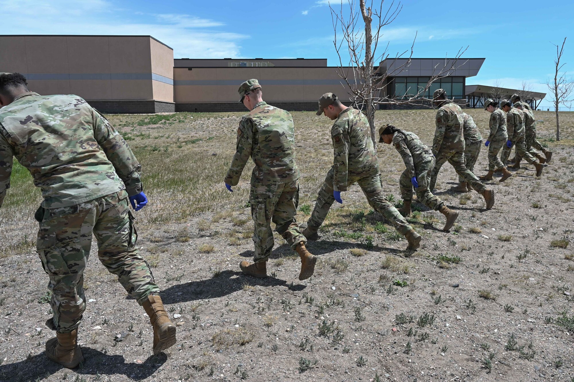 90th Force Support Squadron members participate in search and recovery operations during the 2022 major accident response exercise, June 29, 2022, on F.E. Warren Air Force Base, Wyoming. Search and recovery responders come in during events to locate the injured or person's lost belongings. (U.S. Air Force photo by Airman 1st Class Sarah Post)