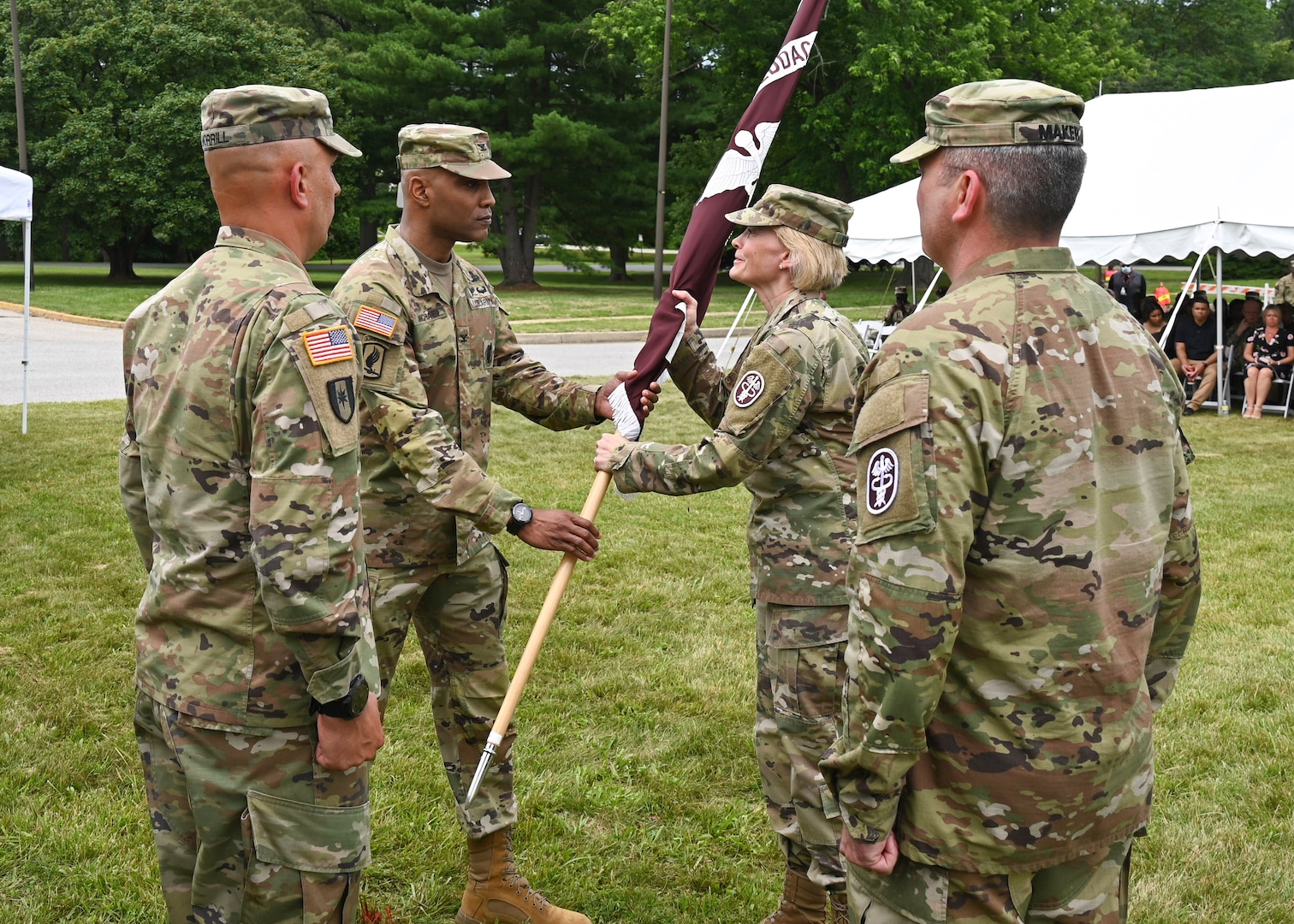 Col. Tracy Michael, outgoing Fort Meade Medical Department Activity commander, passes the unit colors to Commanding General of Regional Health Command – Atlantic Brig. Gen. Mary Krueger at a change of command ceremony held at the Main Entrance of Kimbrough Ambulatory Care Center, June 21, 2022.