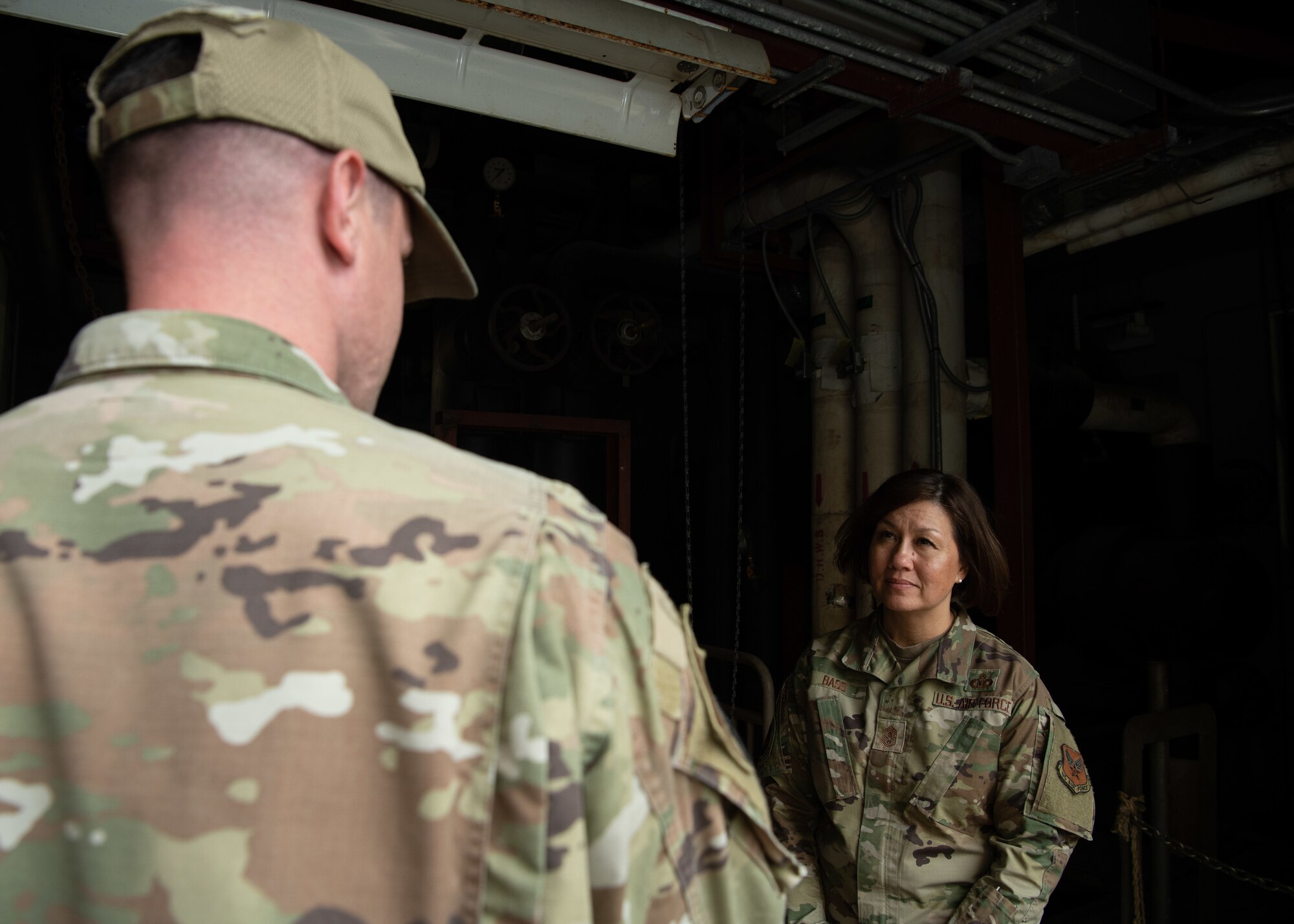 Chief Master Sgt. of the Air Force JoAnne S. Bass, speaks with Cody Rhodes, 8th Civil Engineer Squadron heating, ventilation, and air conditioning craftsman, Wolf Pack, at Kunsan Air Base, Republic of Korea, June 27, 2022. Personnel shared various innovative programs that help the pack optimally perform in the Indo-Pacific theater. (U.S. Air Force photo by Staff Sgt. Sadie Colbert)
