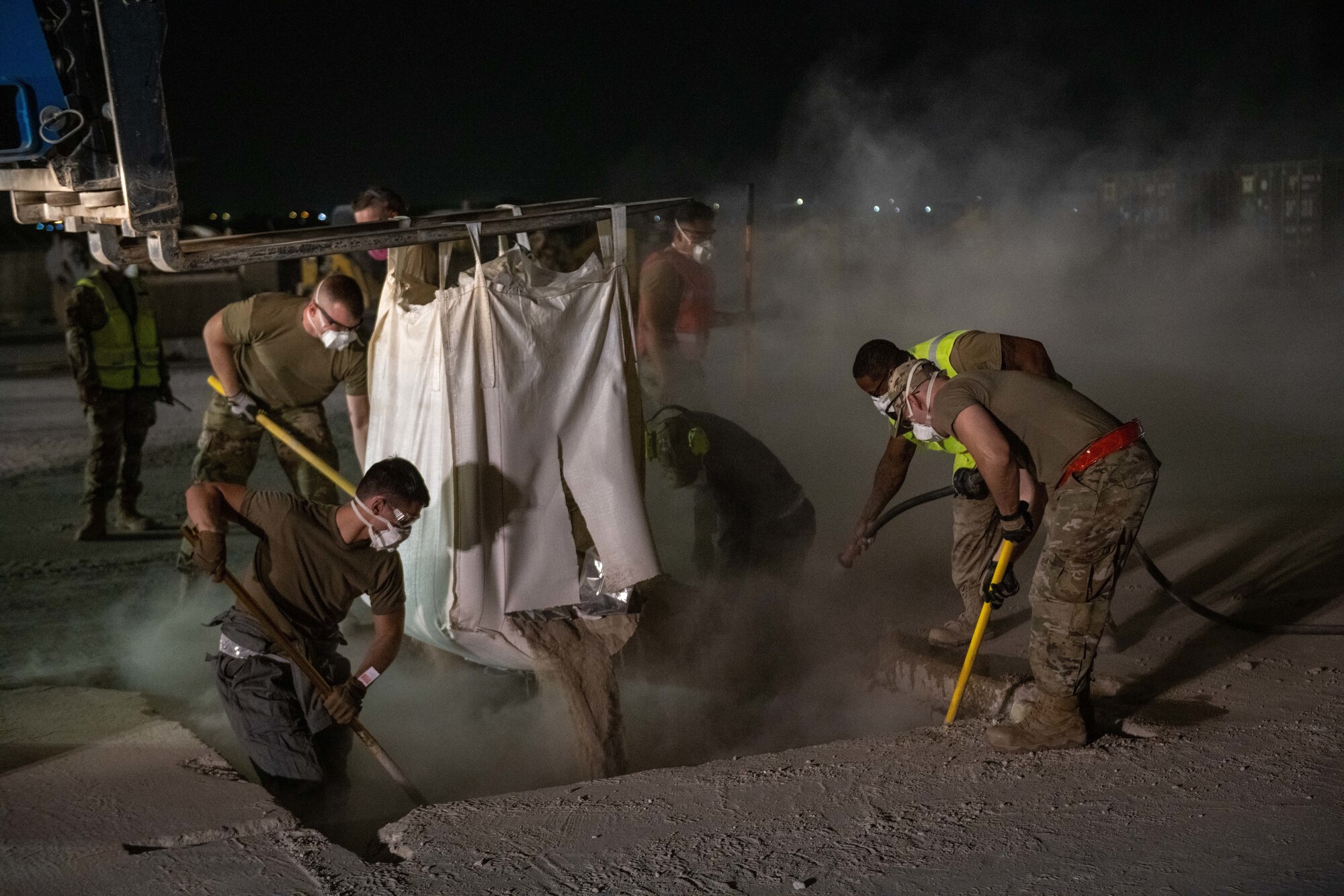 U.S. Air Force civil engineers with the 379th Expeditionary Civil Engineer Squadron repair a crater during an exercise on Al Udeid Air Base, Qatar, June 27, 2022. A quick-setting concrete is used to repair flight lines as quickly as possible. (U.S. Air National Guard photo by Airman 1st Class Constantine Bambakidis)
