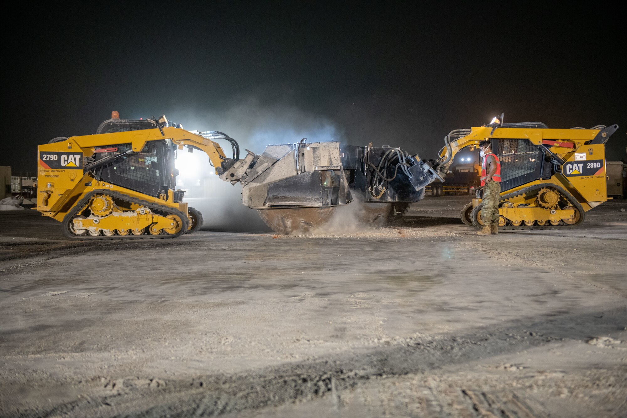 U.S. Air Force engineer assistants with the 379th Expeditionary Civil Engineer Squadron remove craters on a simulated flight line during a flight line repair exercise on Al Udeid Air Base, Qatar, June 27, 2022. After being removed, the leftover cavity will be filled with fresh concrete. (U.S. Air National Guard photo by Airman 1st Class Constantine Bambakidis)