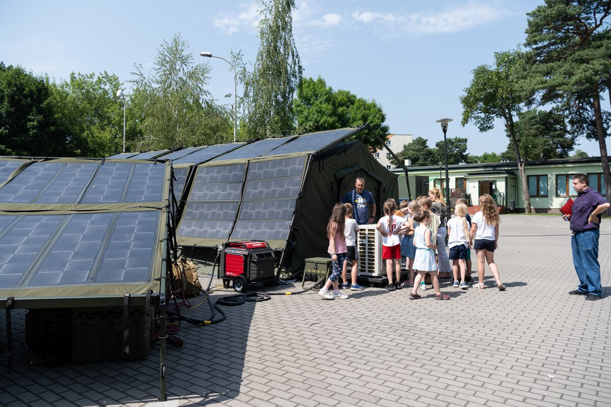 Airman gives a demonstration of Project Arcwater to children at a summer camp.
