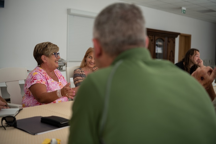 People conduct a meeting.