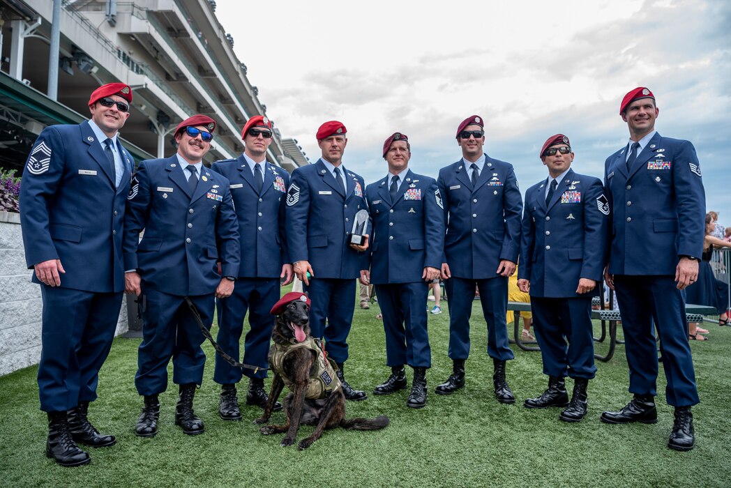 Eight Airmen from the Kentucky Air National Guard’s 123rd Special Tactics Squadron prepare to present a trophy following a thoroughbred horse race at Churchill Downs in Louisville, Ky., June 12, 2022, honoring Tech. Sgt. Travis Brown, a pararescueman from the 123rd STS who died Feb. 16. More than 150 Airmen, friends and family members attended the event to pay their respects. (U.S. Air National Guard photo by Tech. Sgt. Joshua Horton)