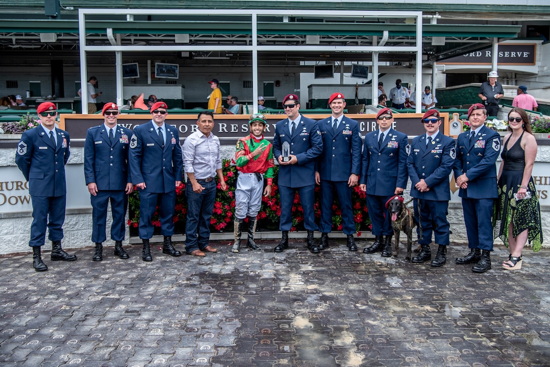 Eight Airmen from the Kentucky Air National Guard’s 123rd Special Tactics Squadron present a trophy following a thoroughbred horse race at Churchill Downs in Louisville, Ky., June 12, 2022, honoring Tech. Sgt. Travis Brown, a pararescueman from the 123rd STS who died Feb. 16. More than 150 Airmen, friends and family members attended the event to pay their respects. (U.S. Air National Guard photo by Tech. Sgt. Joshua Horton)