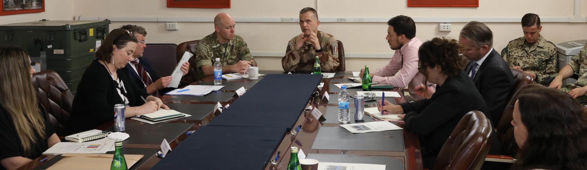 British Royal Air Force Group Capt. Rob O’Dell (left), the director of the Northeast Syria Coordination Group of the Directorate of Civil Environment (DICE), and French Air Force Brig. Gen. Vincent Coste (center), the director of DICE, brief Ambassadorial representatives and aides from multiple Coalition countries about the importance of finding solutions for successfully repatriating individually displaced persons from IDP camps in Iraq and northeast Syria during a meeting June 27, 2022, at Union III forward operating base, in Baghdad, Iraq. The meeting also enabled the DICE team to update the embassy representatives on the current programs and future plans for Combined Joint Task Force – Operation Inherent Resolve’s (CJTF-OIR) advise, assist and enable mission and the Coalition’s role in helping our partners create security and stability in the region. DICE is a directorate of CJTF-OIR. (U.S. Army photo by Sgt. Brian Reed)