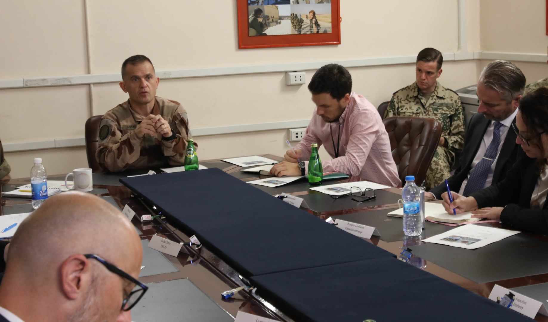 French Air Force Brig. Gen. Vincent Coste (center), the director of Combined Joint Task Force – Operation Inherent Resolve’s (CJTF-OIR) Directorate of Civil Environment, briefs Ambassadorial representatives and aides from multiple Coalition countries about the importance of finding solutions for finding solutions for successfully repatriating individually displaced persons from IDP camps in Iraq and northeast Syria during a meeting June 27, 2022, at Union III forward operating base, in Baghdad, Iraq. The meeting also enabled the DICE team to update the embassy representatives on the current programs and future plans for CJTF-OIR’s advise, assist and enable mission and the Coalition’s role in helping our partners create security and stability in the region. (U.S. Army photo by Sgt. Brian Reed)