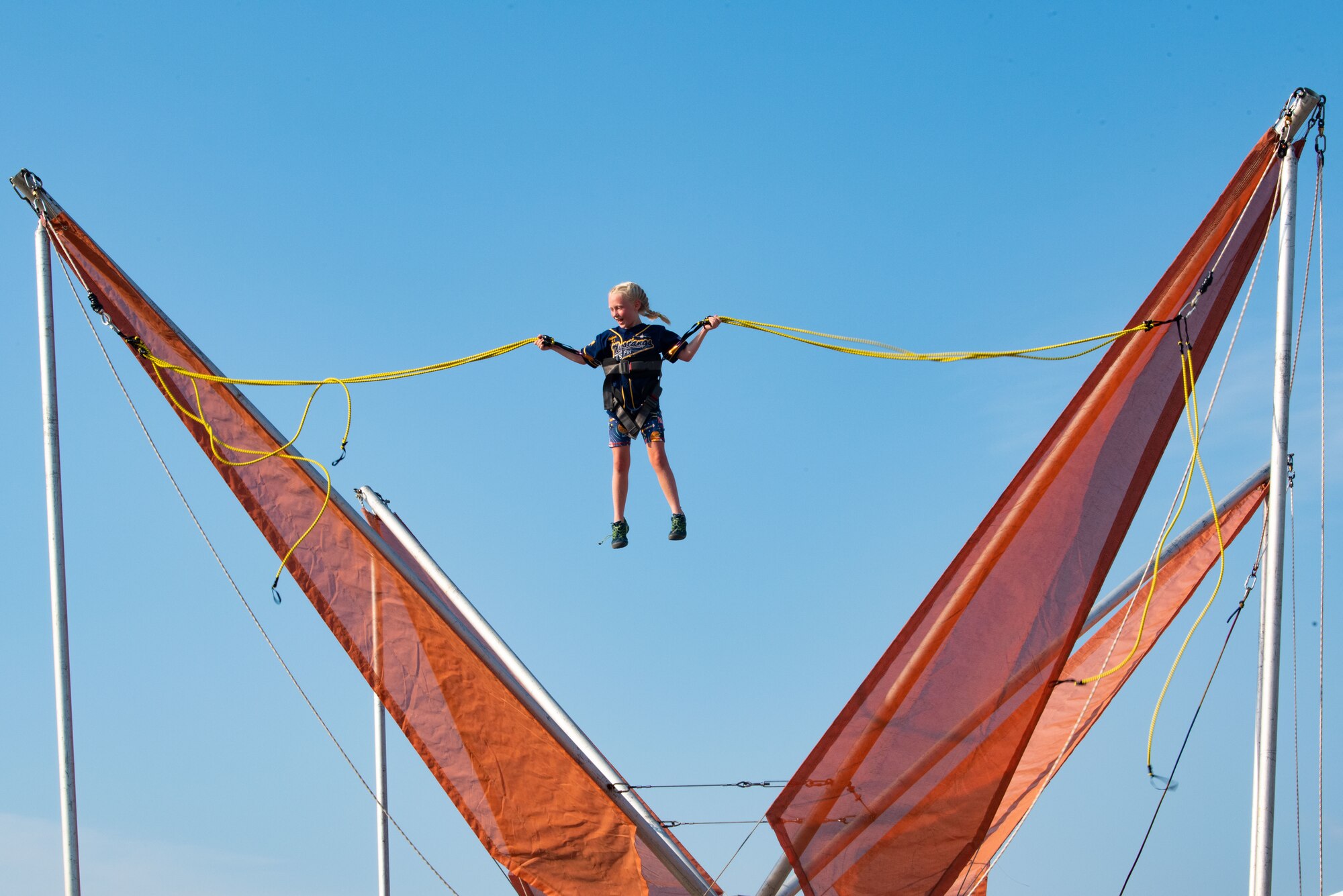 A child jumps on a bungee trampoline during Liberty Fest at Osan Air Base, Republic of Korea, July 2, 2022.