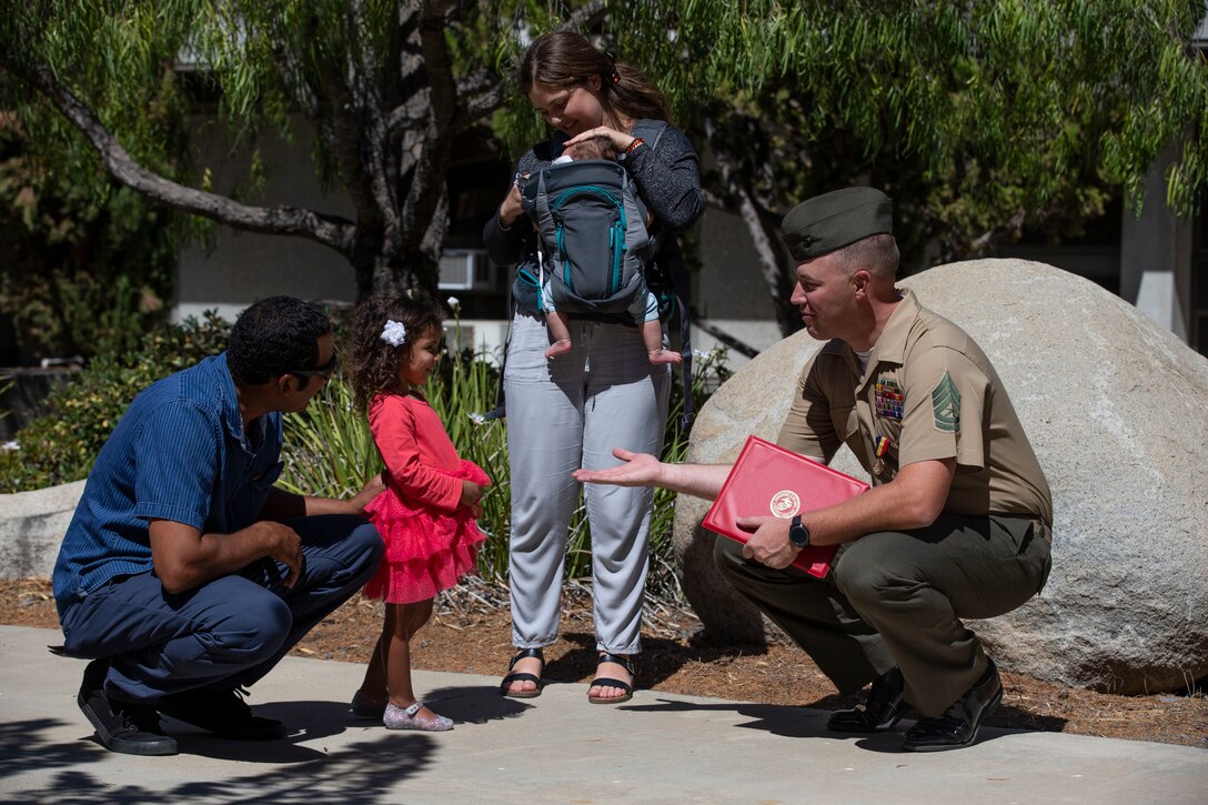 U.S. Marine Gunnery Sgt. Kyle Wetter, the staff noncommissioned officer in charge for the marksmanship training division with Headquarters and Support Battalion, Marine Corps Installations West, Marine Corps Base Camp Pendleton, spends time with the Hurley family after an award ceremony on Camp Pendleton, Calif., June 30, 2022. Wetter was awarded the Navy and Marine Corps Medal for the heroism he displayed in December 2020 after he saw the Hurley’s car burst into flames on the side of a road during his drive home. Wetter climbed into the backseat of the burning car and used a pocket knife to free a child from her car seat.
