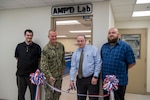 From left: Scott Ziv, a mechanical engineer in Carderock’s Additive Manufacturing Branch; Capt. Todd Hutchison, Commanding Officer; Paul Young, head of the Fabrication and Technical Support Division; and Ryan Franke, a technician in Carderock’s Subtractive and Additive Manufacturing Branch, cut the ribbon during the grand opening of Carderock’s new Advanced Manufacturing Prototyping (AMP) Lab on June 23, 2022. (U.S. Navy photo by Devin Pisner)