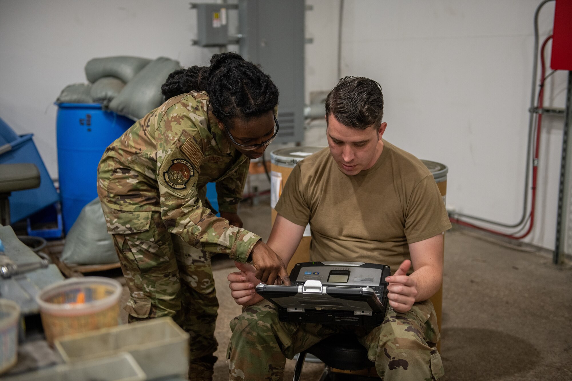 Airmen discuss weapon system schematics